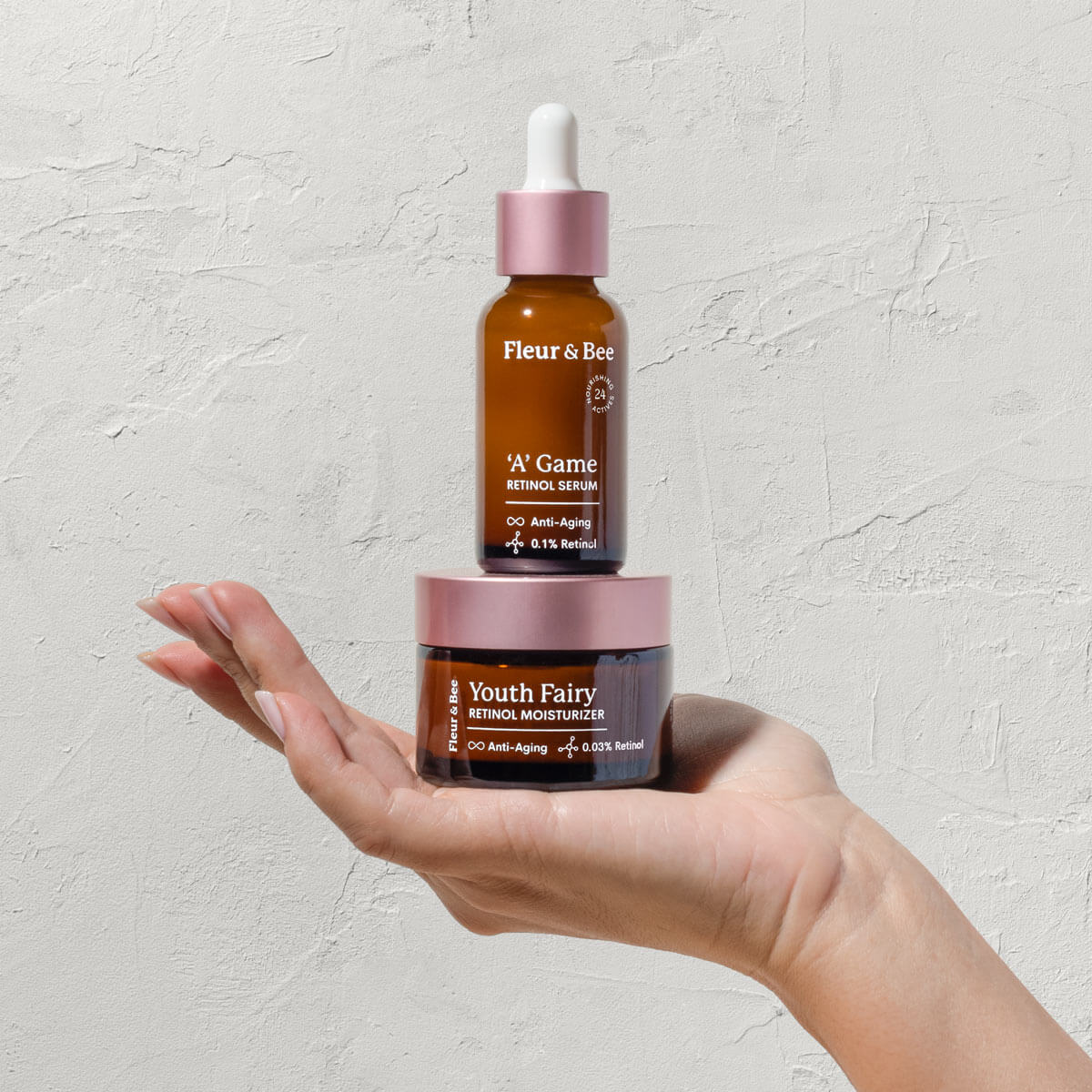 a hand holding an anti aging retinol moisturizer and retinol serum