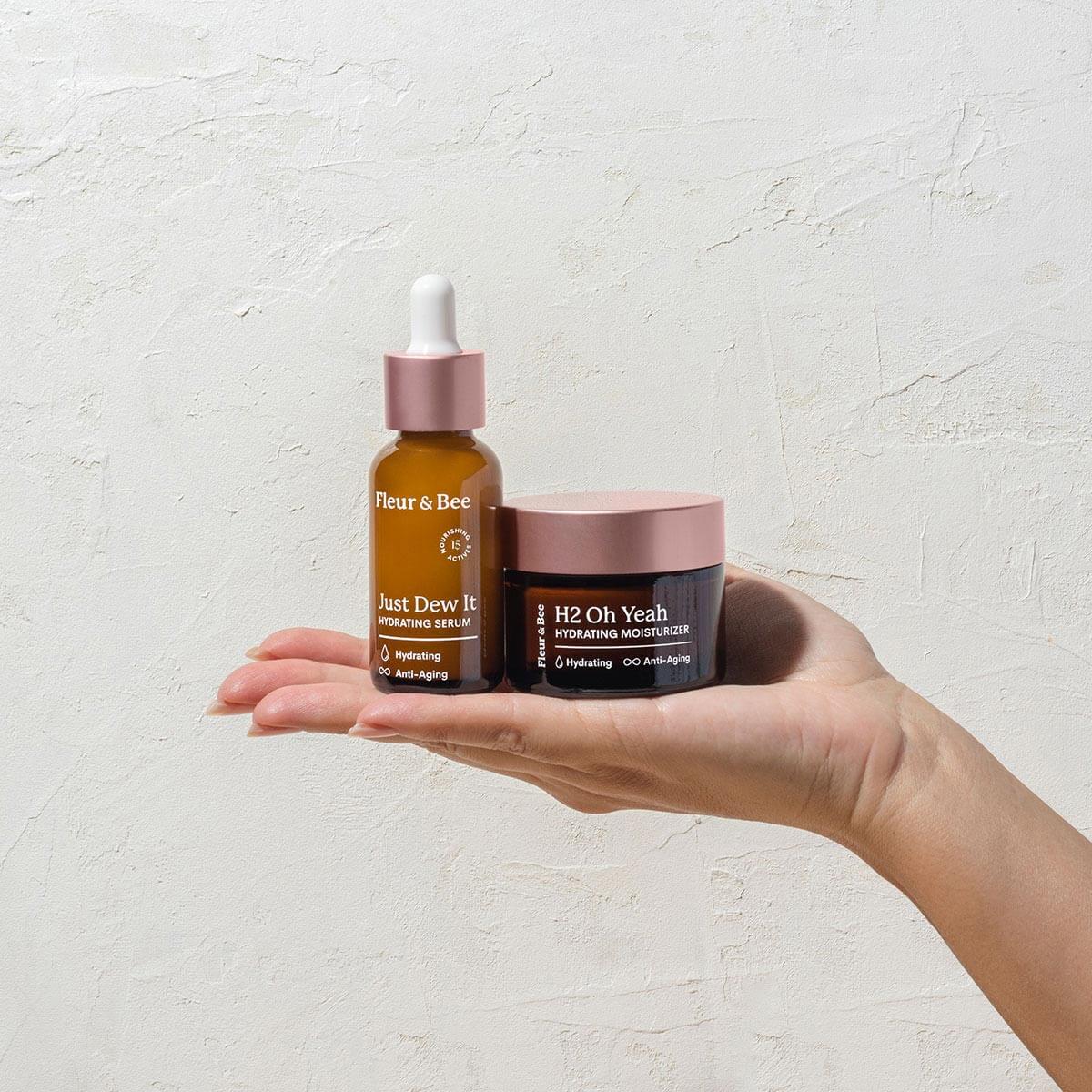 hand presenting Fleur & Bee's vegan hydrating serum and hydrating moisturizer