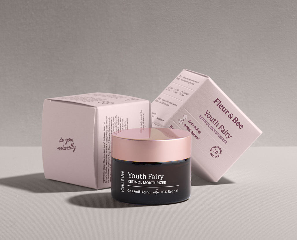 a premium retinol serum next to its packaging