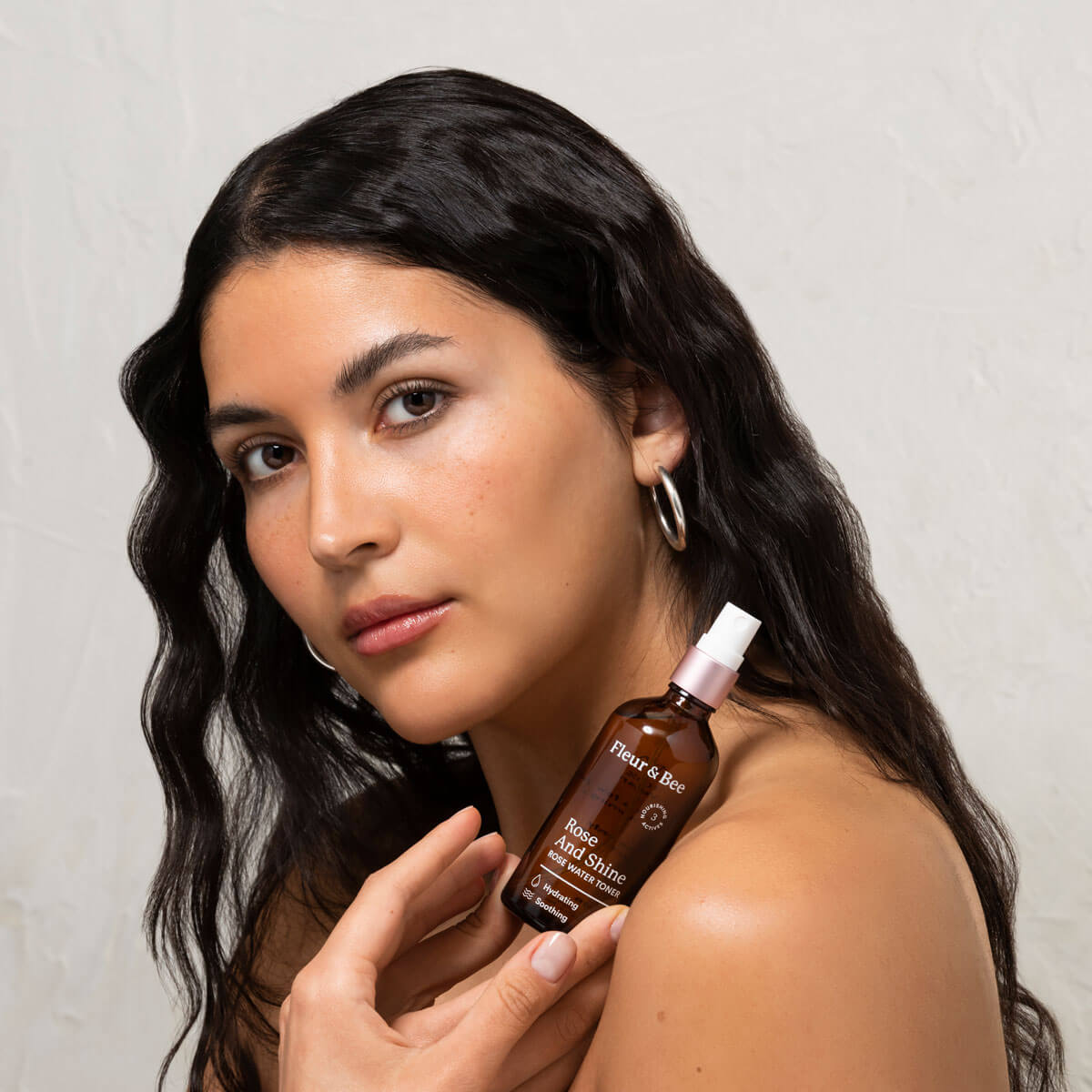 woman holding a luxury rose water toner