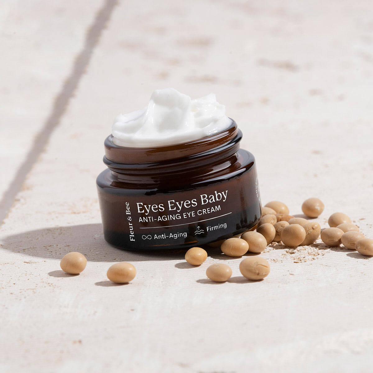 anti-aging eye cream shown with lid off so eye cream texture is visible